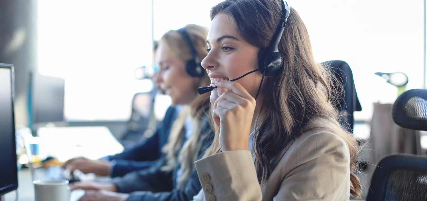 Two people working and looking at the screen